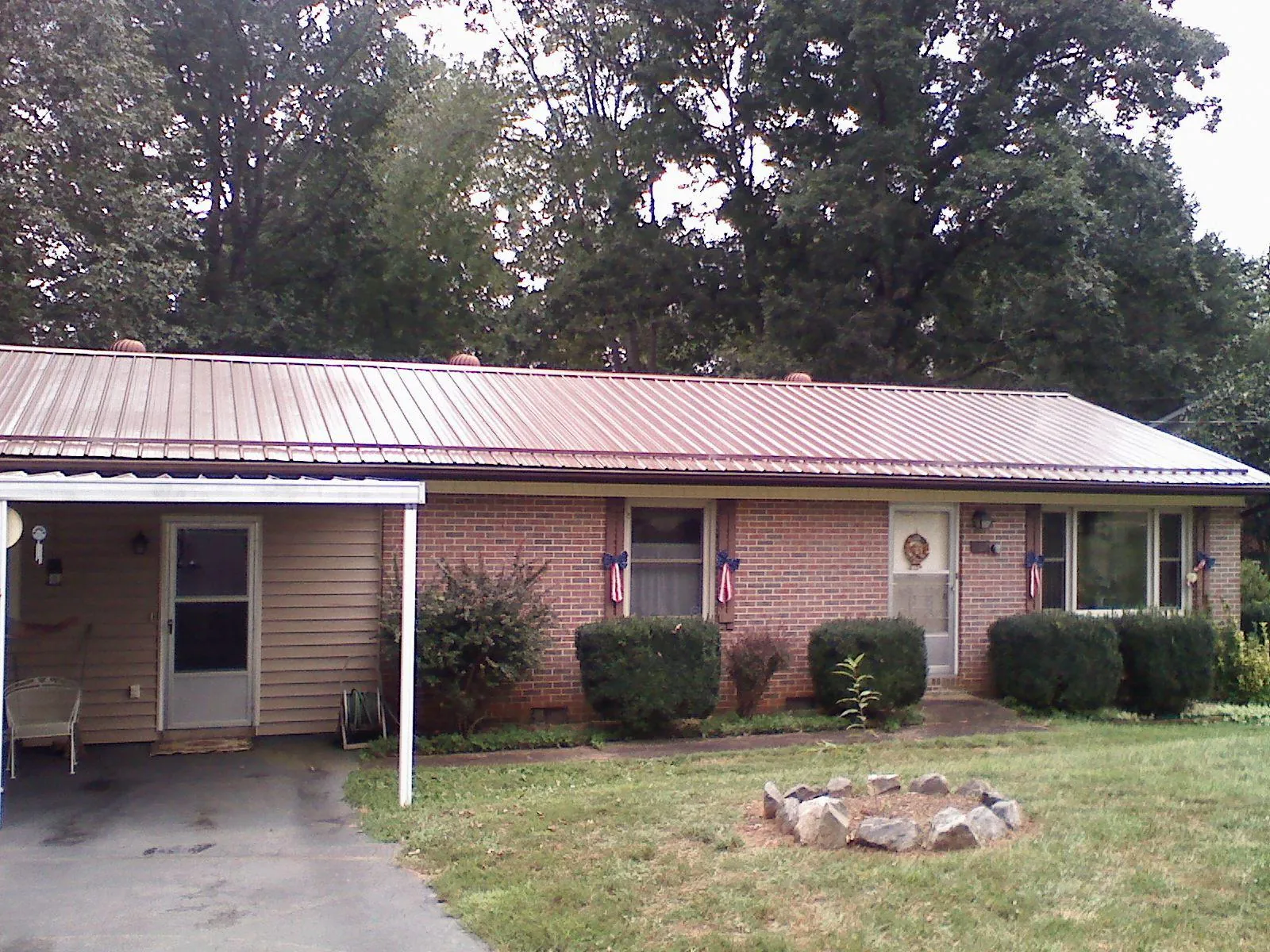 Bronze metal roof and carport on a brick ranch home — Roof Repair work by our crew in Abington